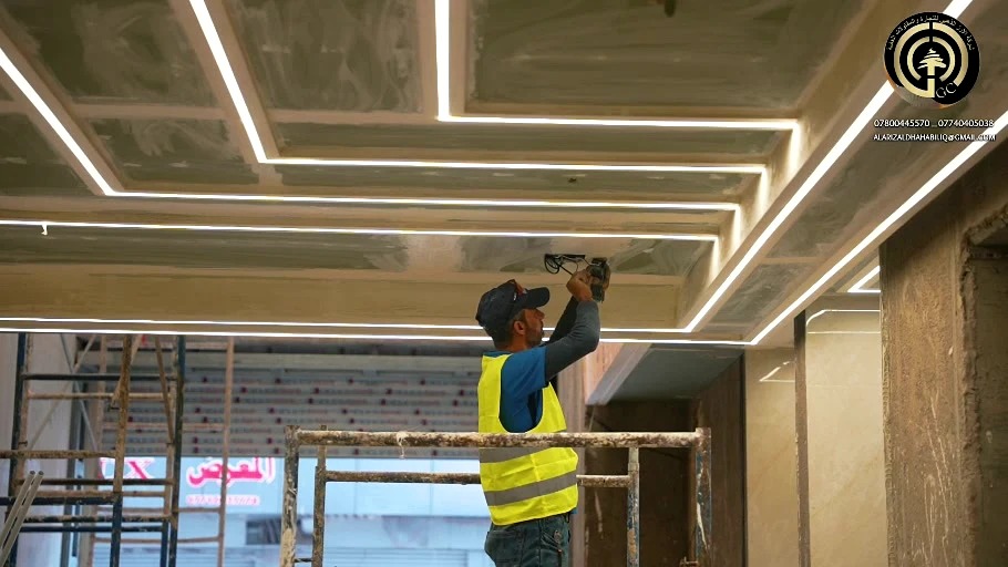 Team member installing ceiling lighting