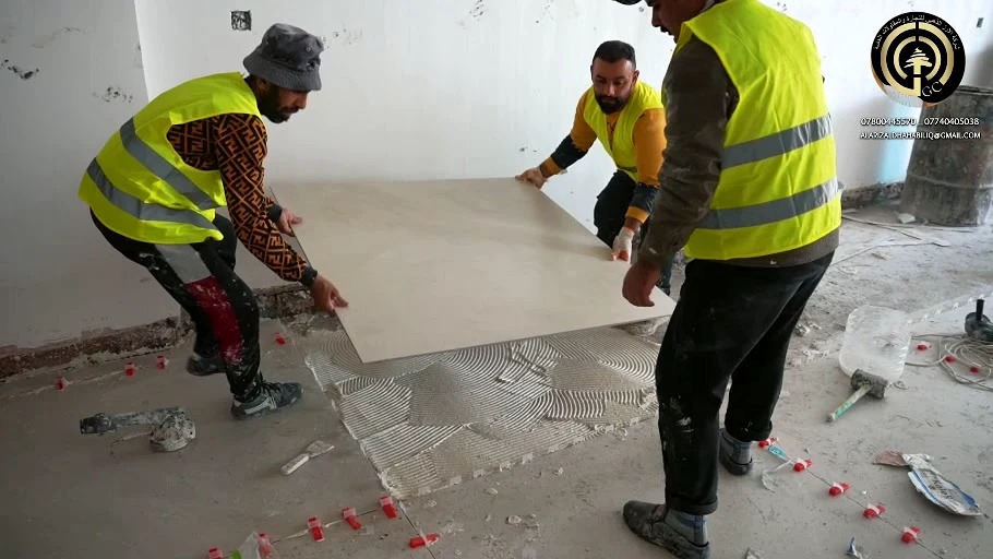 Team positioning a floor tile